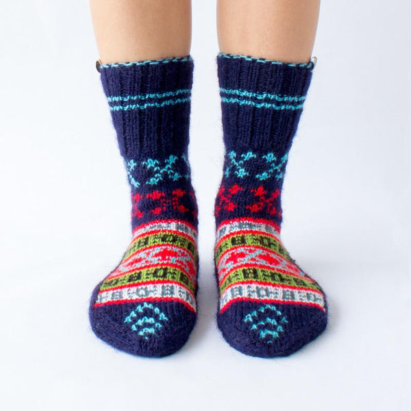 dark blue wool sock with red and light blue details and a beautiful pattern on top, handknitten, vegan and fair trade, frontview