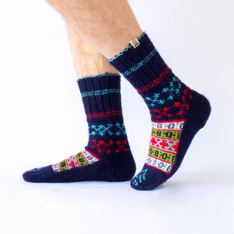 dark blue wool sock with red and light blue details and a beautiful pattern on top, handknitten, vegan and fair trade, sideview
